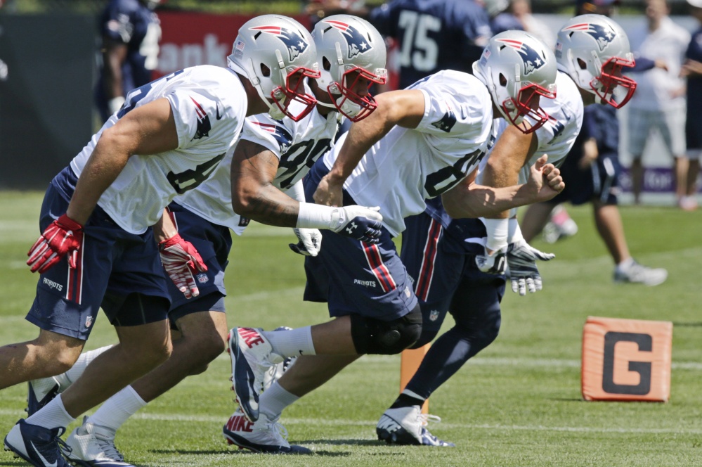 New England Patriots tight end Rob Gronkowski, second from right, dashes during a drill at practice Wednesday in Foxborough, Mass. The Patriots play the Carolina Panthers tonight in a preseason game at Gillette Stadium.