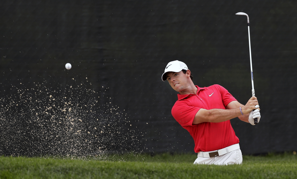 Rory McIlroy hits from a bunker on the 13th hole during the first round of play Thursday at The Barclays in Paramus, N.J.  McIlroy shot a 3-over 74, his worst start in two months.