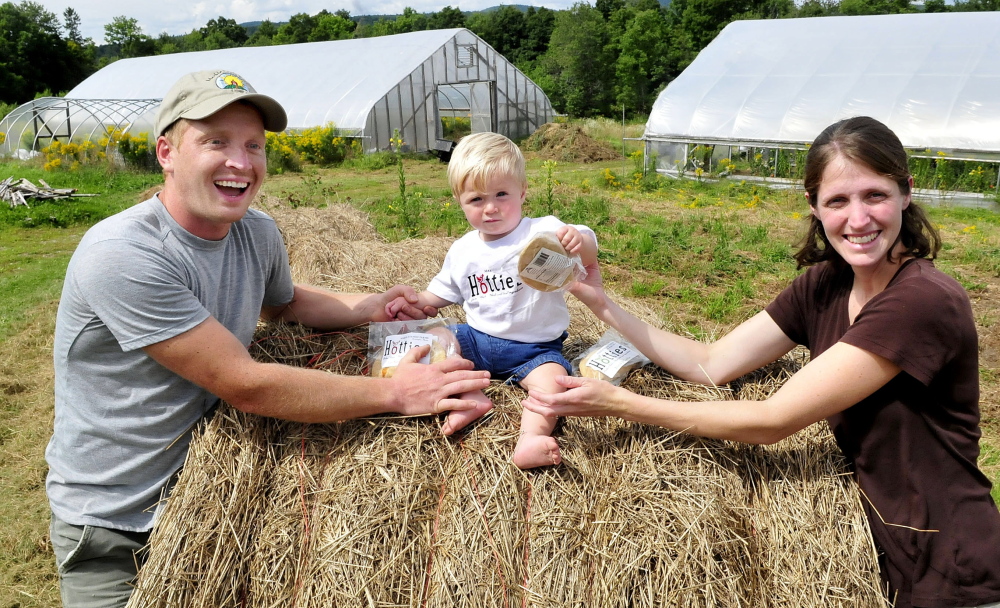 Andy and Sarah Marble and their son Avery at the Marble Family Farm in Farmington on Thursday.