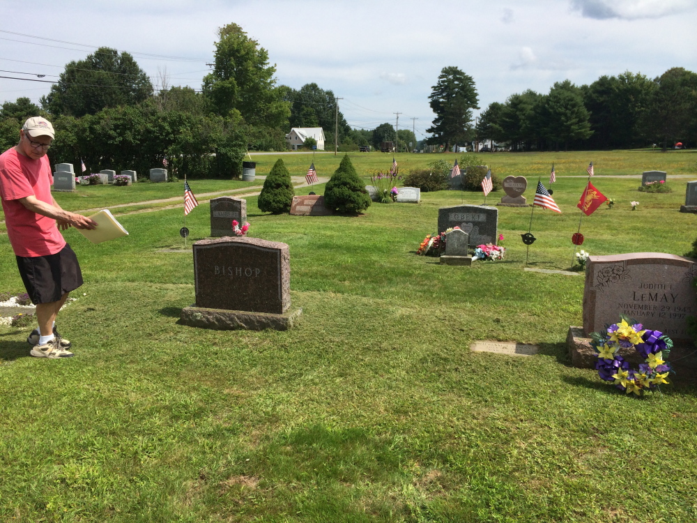 Stephen Bishop, of Norridgewock, walks through his family’s cemetery plot at Sunset View Cemetery on Thursday. Bishop is asking the town for help removing two headstones and remains that do not belong to his family from the plot.