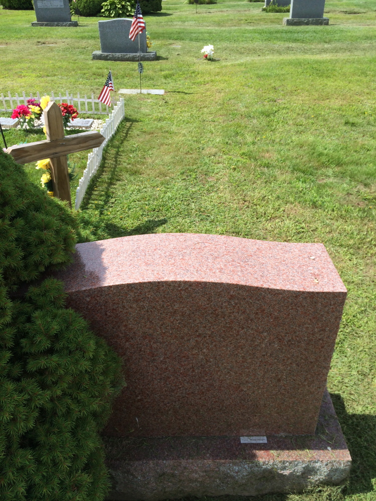 Normal:A view of the back of Judith LeMay’s headstone shows that it straddles the property line between two plots in Sunset View Cemetery in Norridgewock