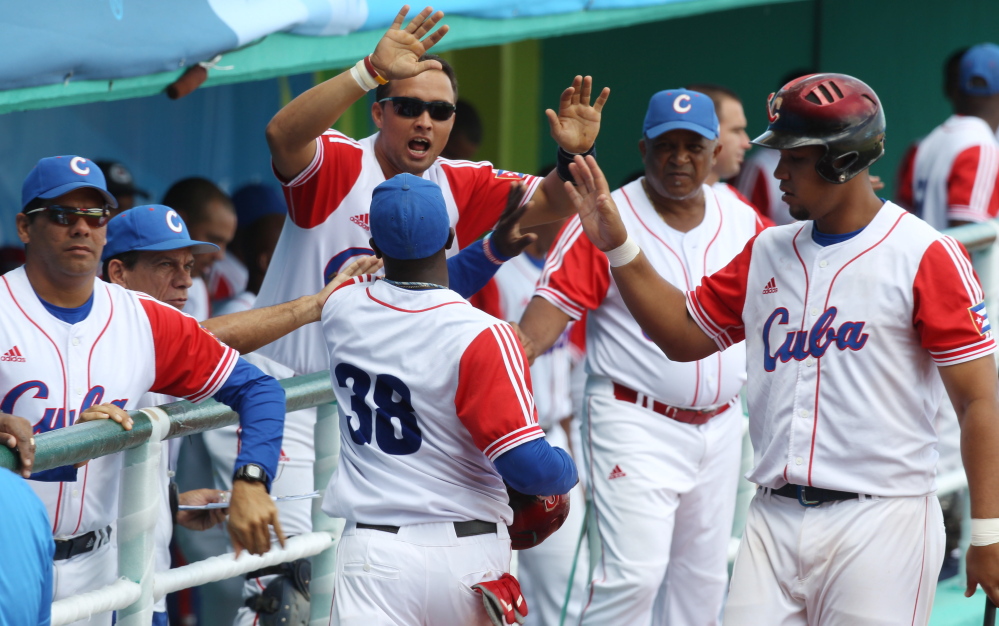 Cuba’s Rusney Castillo (38) celebrates with teammates after scoring during a baseball game against Venezuela at the Pan American Games in Lagos de Moreno, Mexico. Castillo has been signed by the Red Sox, according to media reports.