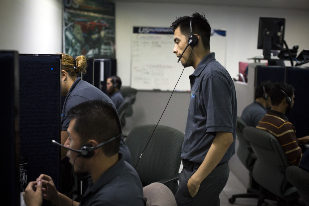Men work the phones at the Firstkontact Center, a call center in the northern border city of Tijuana, Mexico.