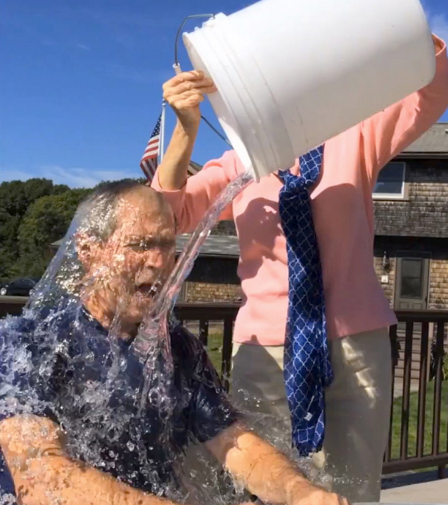 In this image from video posted on Facebook, courtesy of the George W. Bush Presidential Center, former President George W. Bush participates in the ice bucket challenge with the help of his wife, Laura Bush, in Kennebunkport, Maine. The challenge has caught on with notable figures participating in the campaign to raise money for the fight against ALS, or Lou Gehrig's disease.  The phenomenal success of the fundraising craze is making charitable organizations rethink how they connect with a younger generation of potential donors, specifically through social media. (AP Photo/Courtesy George W. Bush Presidential Center)