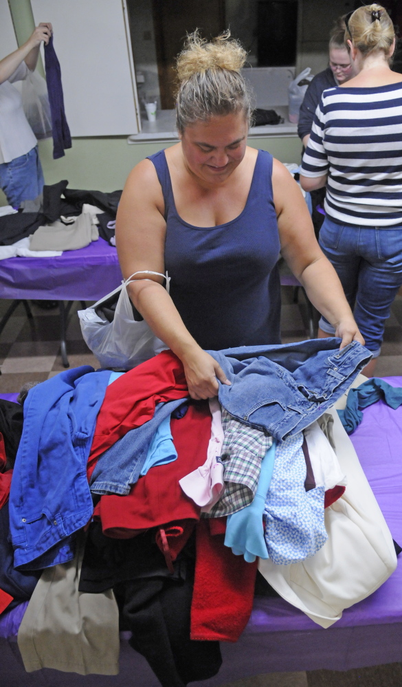 Tricia Hawk, of Vassalboro, looks for items during a clothing giveaway Saturday at Kennebec Community Church in Augusta.
