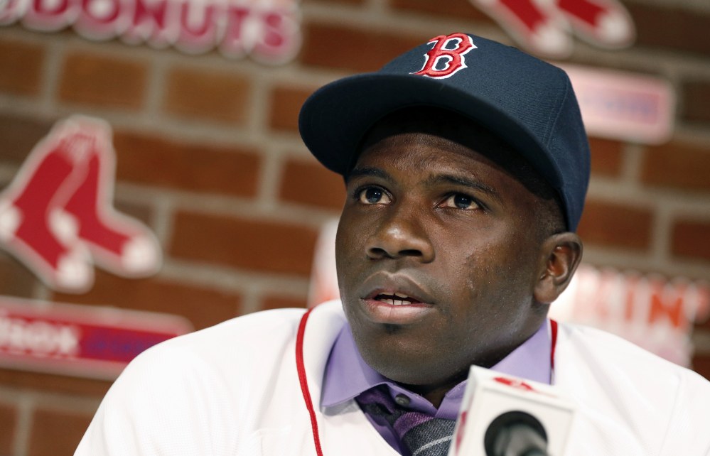 Rusney Castillo talks with reporters Saturday in Boston. The Red Sox announced they signed Castillo, a Cuban defector, to a seven-year contract, beginning in 2014.