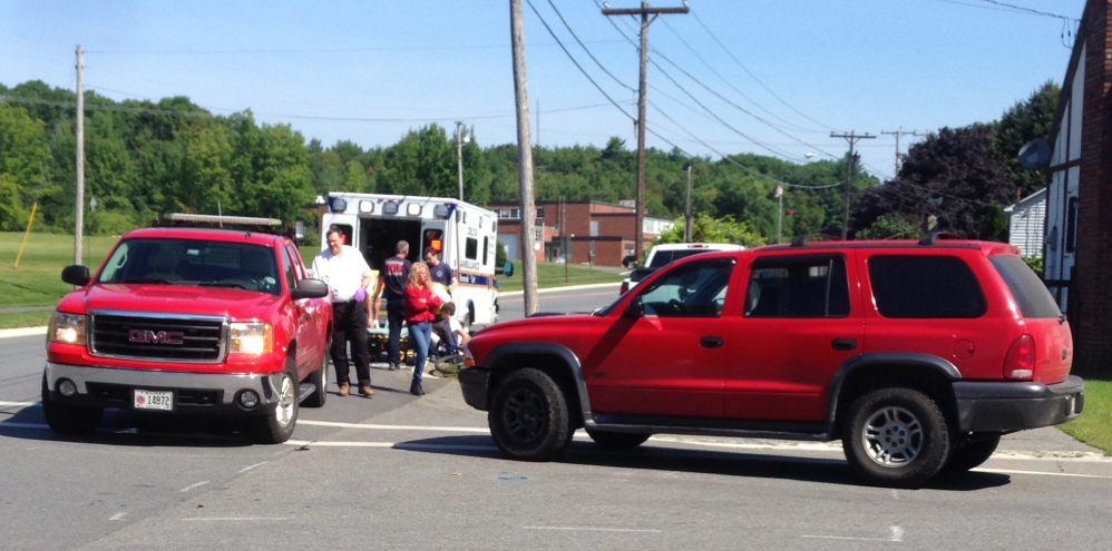 A  teenaged boy was hurt when a Dodge SUV, right, collided with the bicycle the boy was riding at about 10:30 a.m. Monday.  The boy was taken by ambulance for hosptial treatment.
