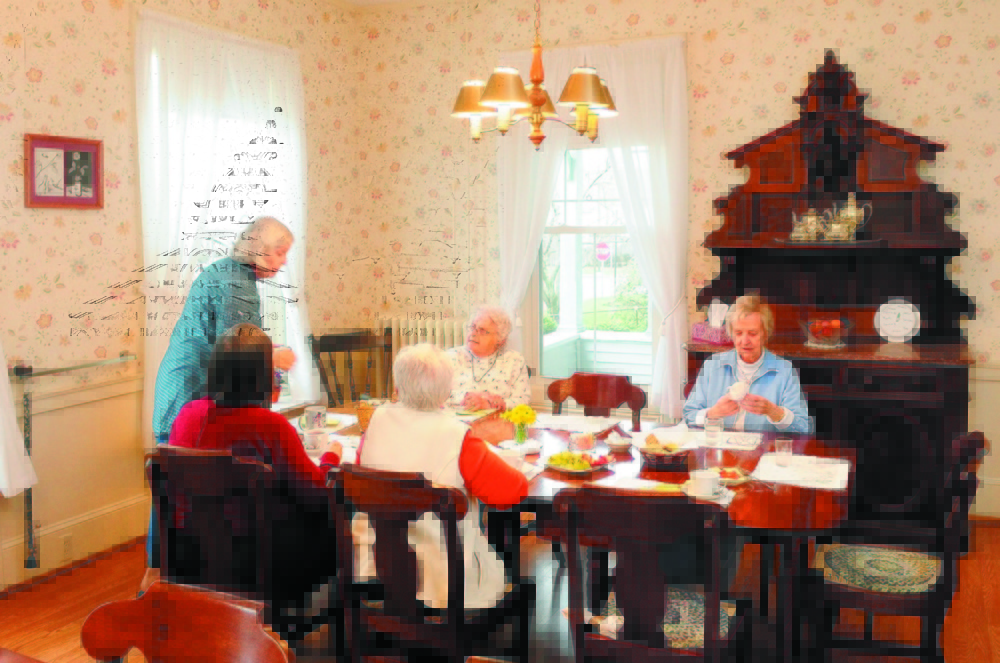 Women enjoy daily afternoon tea at St. Mark’s Home in Augusta in this 2011 photo. Some of the furniture in the dining room is from the home’s original owner, Alan Lambard, who died in 1877.