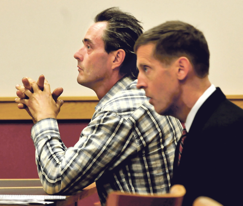 Defendant Robert Dale, left, and his attorney, Walter McKee, listen to testimony during a hearing at Skowhegan District Court Monday. Dale is facing a charge of contempt for not cleaning up his Maine 201 Antiques business in Fairfield as ordered by the town.