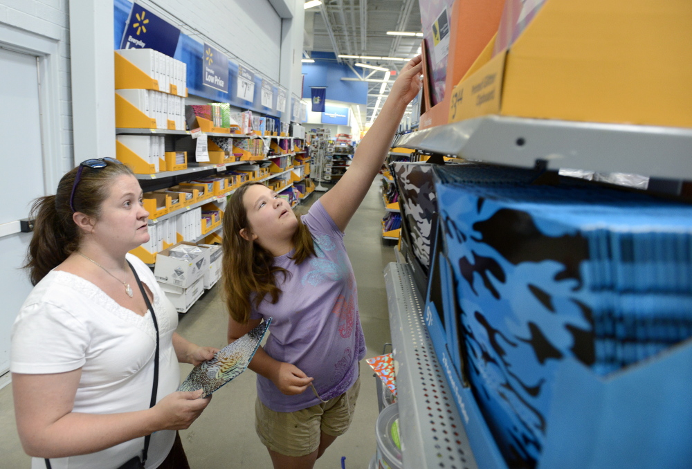 Rigina Lemire, of Westbrook, and her 10-year-old daughter, Saige, shop for school supplies Aug. 20 at Walmart in Scarborough.