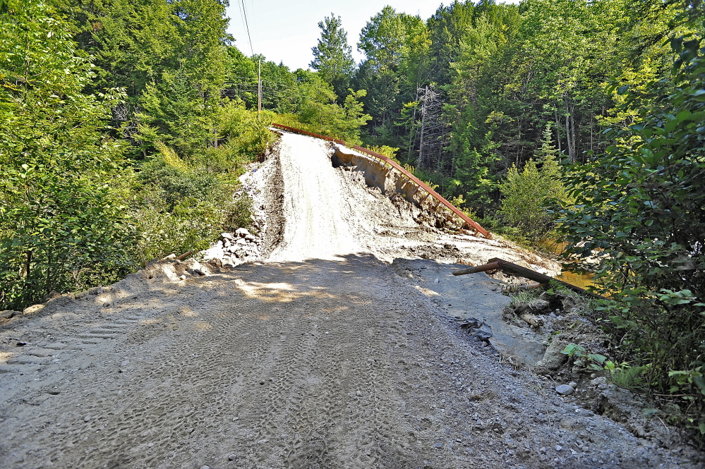 This private road in Freeport, shown Tuesday, used to be 15 to 20 feet higher but was washed out in the latest storm. It is partially usable after a construction crew put in a culvert and added tons of fill to make it passable. The cost of a complete repair is estimated to be $85,000, according to Arleen Siegert-Young, who uses it as the only way to reach to her home.