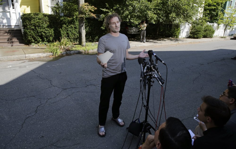 Peter Theo Curtis reads a statement to reporters outside his mother’s home in Cambridge, Mass., Wednesday.