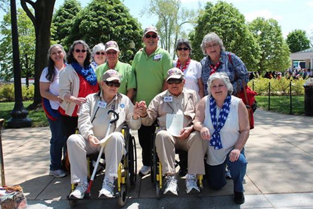 At the World War II Memorial, front, from left, is Robert Butler, holding hands with his twin brother Richard Butler, along with daughter Karen Roak of Augusta; and back, from left, are daughter Dee Dee Love of Farmingdale, daughter Nancy Butler-Smith of Monmouth, daughter Debbie Sylvester of Manchester, Robert’s guardian Andy Frederick of Florida, Richard’s guardian Dennis McCullough of Florida, daughter Judy Moody of Gardiner, and daughter Linda Pekins of Farmingdale. Robert has a daughter, Lori Craig of Houlton. The brothers are holding letters of recognition that they received from Sen. Angus King’s office.