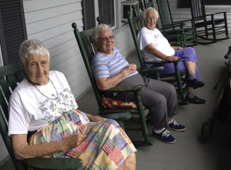 Residents of St. Mark’s Home in Augusta, from left, Margaret Jamison, Eva Sherwood and Nona Treworgy rock in the shade of the east-facing porch and talk about how much they have enjoyed living there. The home is slated to close by the end of the year, and they will have to move.