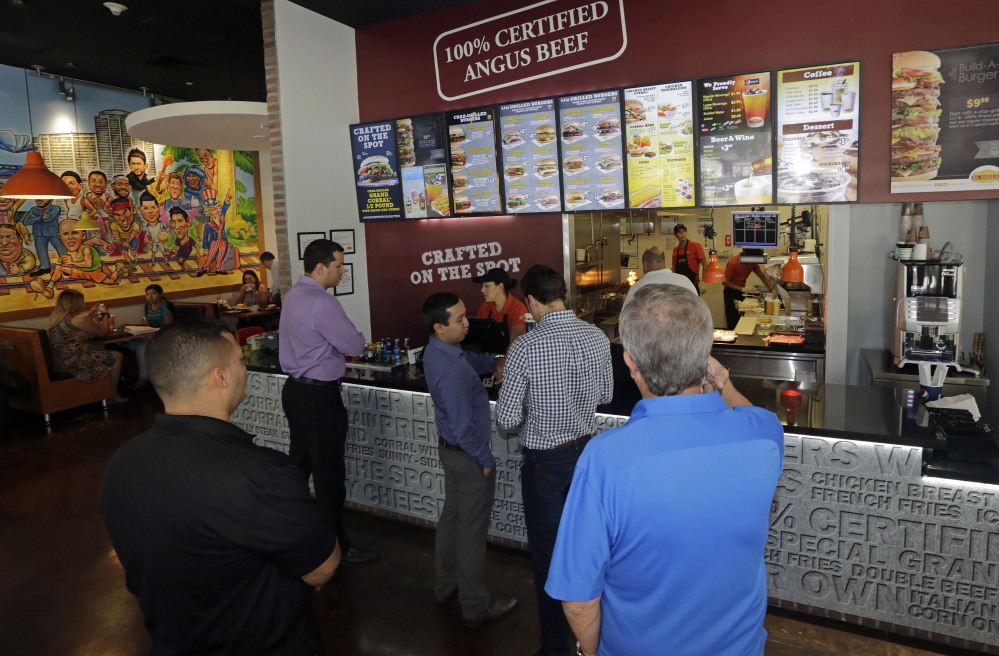 Customers line up to order lunch at El Corral restaurant in Miami. Colombian hamburger chain El Corral has over 200 locations in Latin America and  arrived to the U.S. in early 2013.
