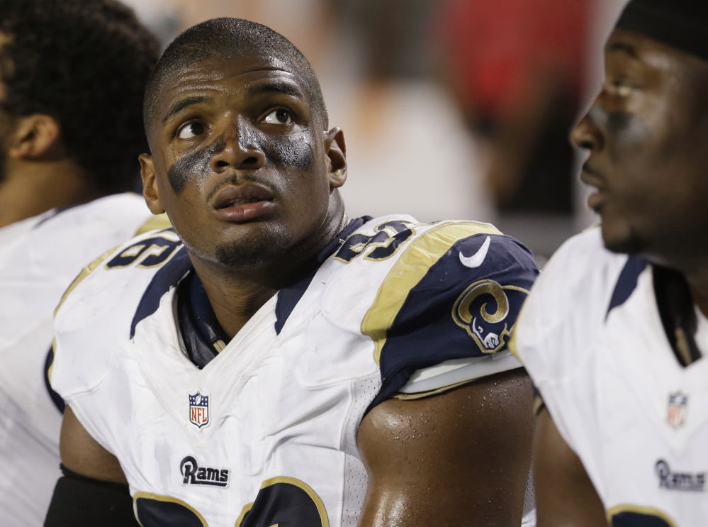 St. Louis Rams defensive end Michael Sam (96) looks up at the scoreboard from the sidelines during the first half of an NFL preseason football game against the Miami Dolphins, Thursday.