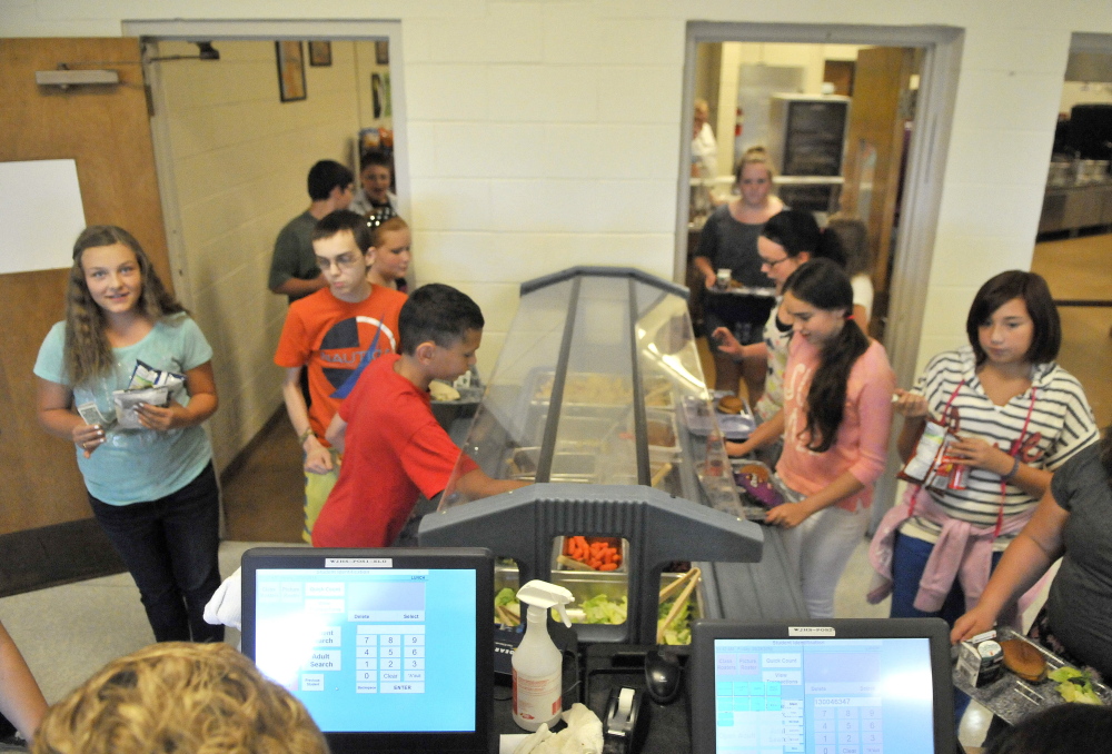 Students help themselves at the salad bar during lunch period Friday at Waterville Junior High School.