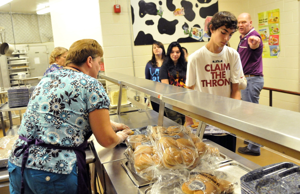 Students get lunch at the cafeteria Friday during school at Waterville Junior High School.