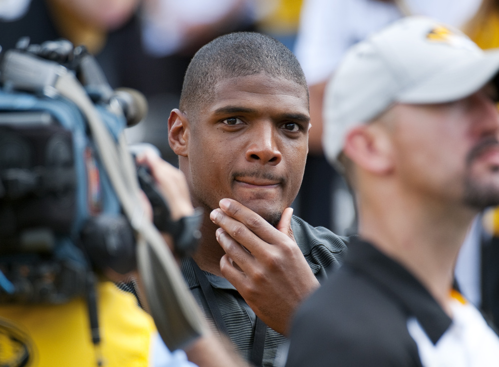 Michael Sam watches pregame festivities before the start of the South Dakota State-Missouri game on Saturday. Sam, who played for Missouri last year, is first openly gay player drafted by an NFL team. He was released by the Rams on Saturday.