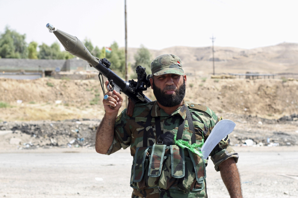 A Shiite militiaman stands guard in Amirli, where 15,000 Shiite Turkmens were stranded in the farming community surrounded by militants since mid-July, 105 miles (170 kilometers) north of Baghdad, Iraq.  Iraqi security forces and Shiite militiamen on Sunday broke a six-week siege imposed by the Islamic State extremist group on the town of Amirli, following U.S. airstrikes against the Sunni militants’ positions, officials said.