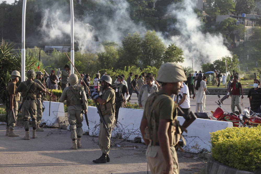 Pakistani paramilitary troops stand guard during a clash between police and protesters in Islamabad, Pakistan on Monday.