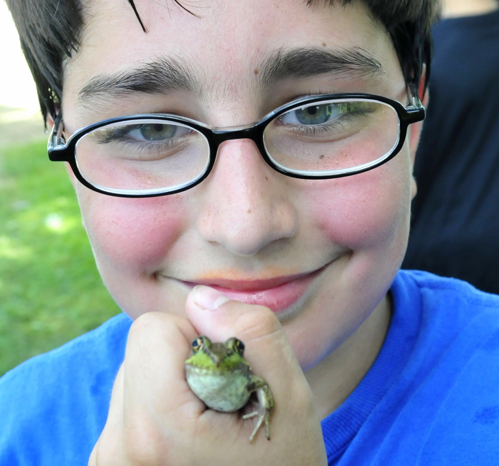 Mathew Nichols competed with his frog Speckles during the popular frog jumping contest at the Oosoola Fun Day in Norridgewock on Monday. Though Mathew did not win, he sold 11 frogs he collected over the weekend to kids who needed one for the contest.