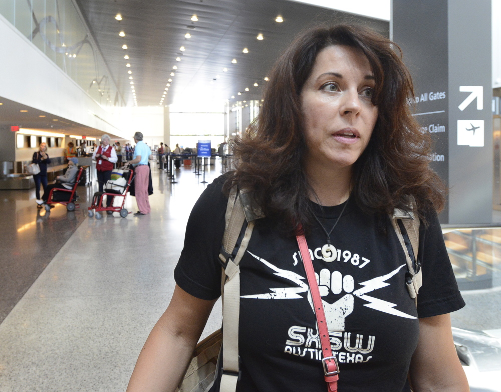 Susan Sanders, of Los Angeles, is among travelers at Portland International Jetport who gave their views Tuesday about quarrels between passengers who want to recline their seats and passengers behind them who object to it.