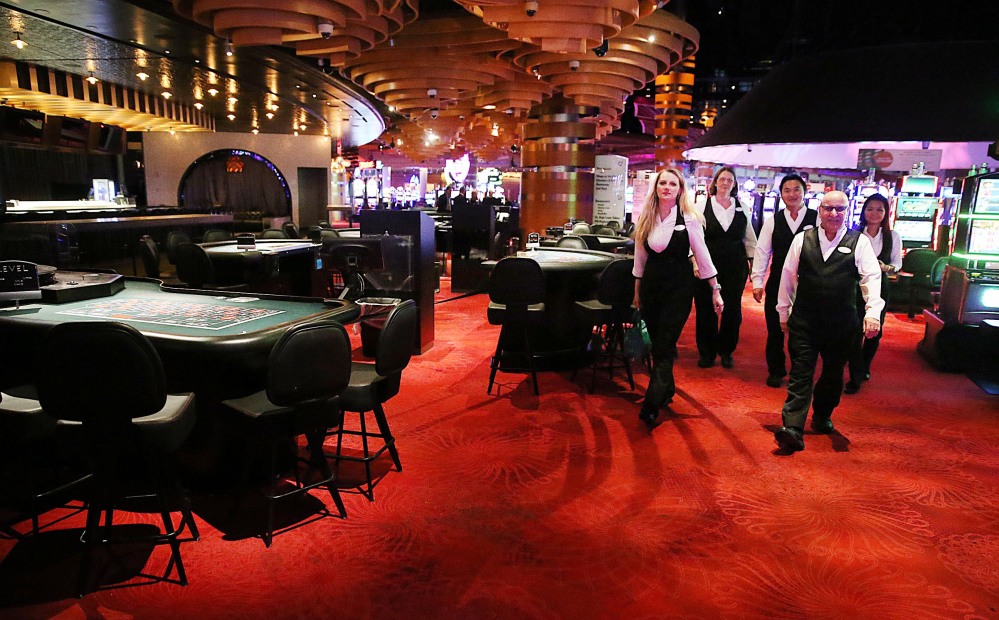 Dealers leave the casino after their last shifts before the casino closes, Tuesday in Atlantic City, N.J.