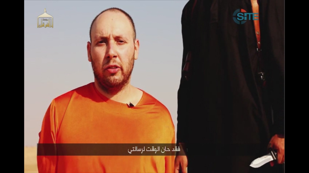 This image made from video posted on the Internet by Islamic State militants and provided by the SITE Intelligence Group, a U.S. terrorism watchdog, appears to show journalist Steven Sotloff before he was killed.