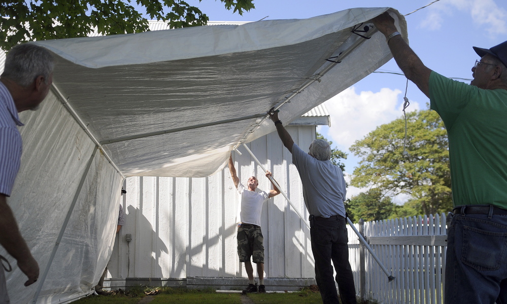 Volunteers erect one of ten canopies for vendors Wednesday at the Litchfield Fair. The annual agricultural exhibition begins Friday and wraps up Sunday.