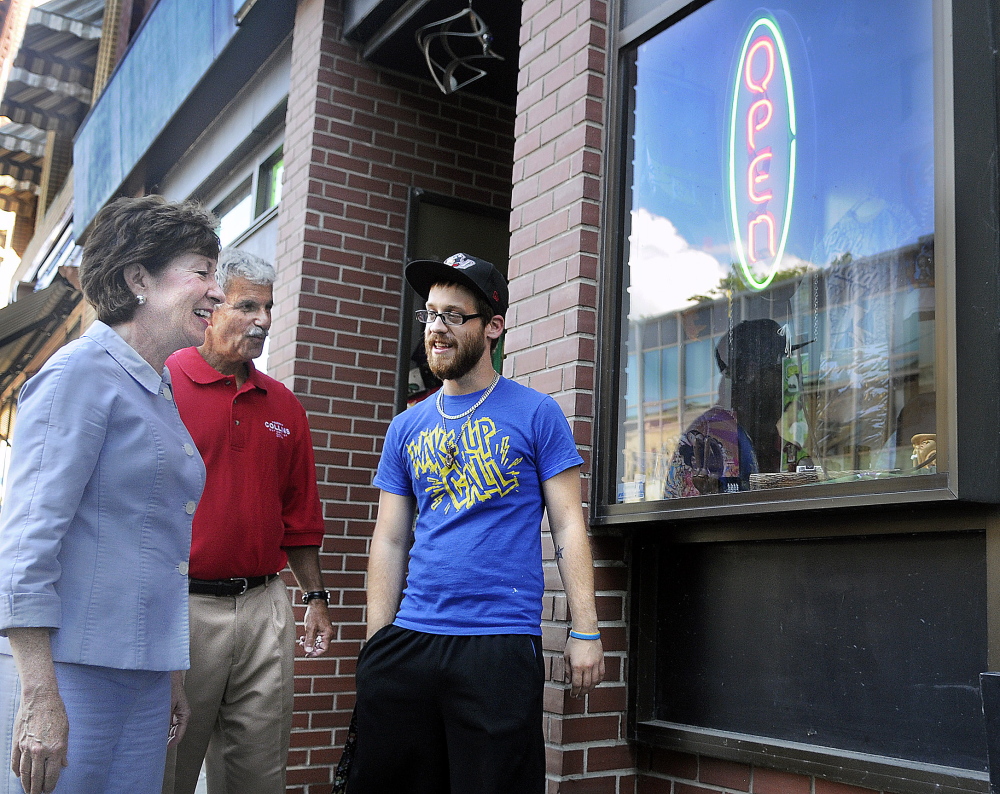 U.S. Sen. Susan Collins and State Sen. Roger Katz, R-Augusta, speak with Ralph Arbour on Wednesday outside Cosmic Charlie’s in Augusta, where Arbour works. Katz accompanied Collins on a campaign swing through the downtown.