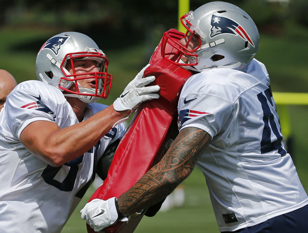 New England Patriots tight ends Rob Gronkowski, left, and Michael Hoomanawanui perform a drill during a recent practice in Foxborough, Mass. The Patriots are preparing for their opening game against the Miami Dolphins on Sunday in Miami.