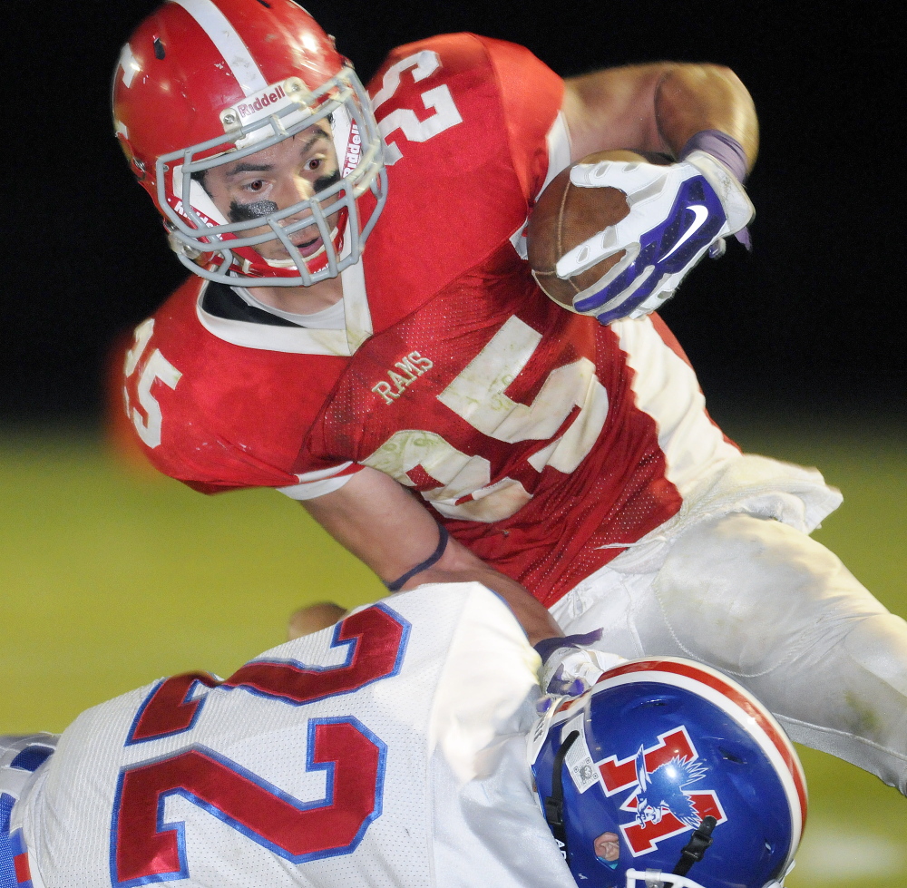 Messalonskee defender Josh Boucher tackles Cony wide receiver Tayler Carrier during a Pine Tree Conference Class B game Friday night.