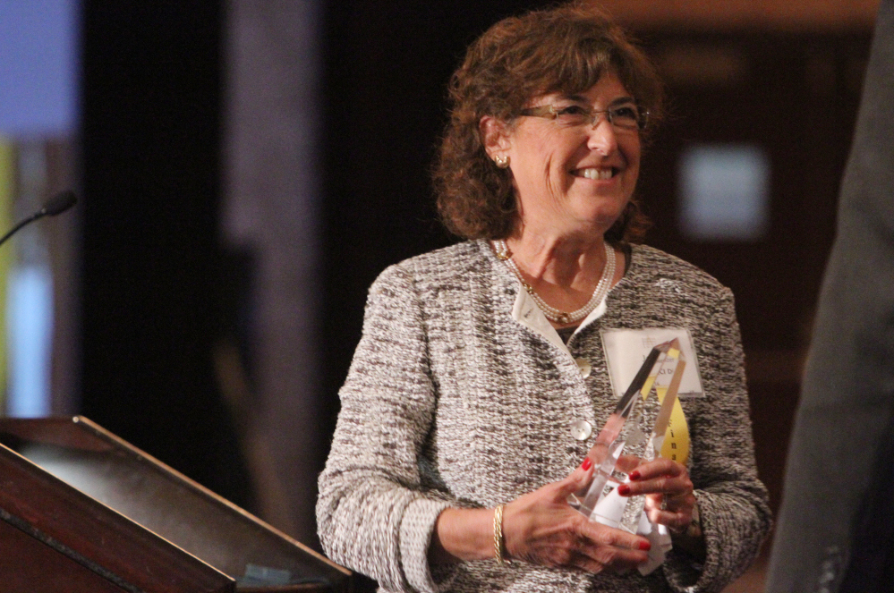 In this Sept. 18, 2012 photo, Jane Glazer, owner of QCI Direct of Chili, heads back to her seat after winning a Rochester Business Ethics Award at the Riverside Convention Center in Rochester, N.Y.