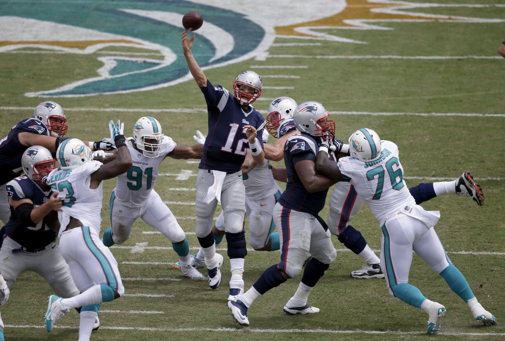 Patriots quarterback Tom Brady passes against the Miami Dolphins in the first half Sunday at Miami Gardens, Fla.
