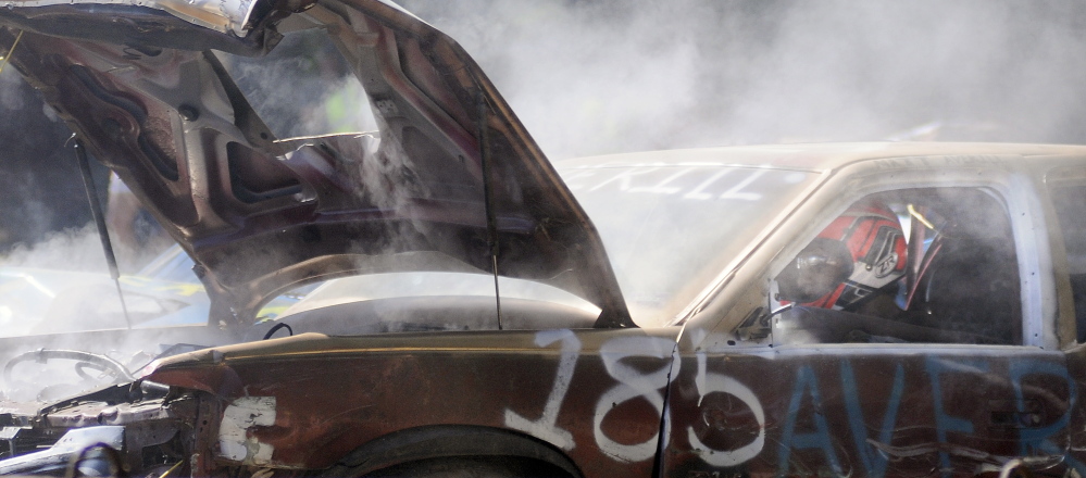 Matt Averill drives his Cadillac toward an opponent Sunday during the demolition derby held at the Litchfield Fair.