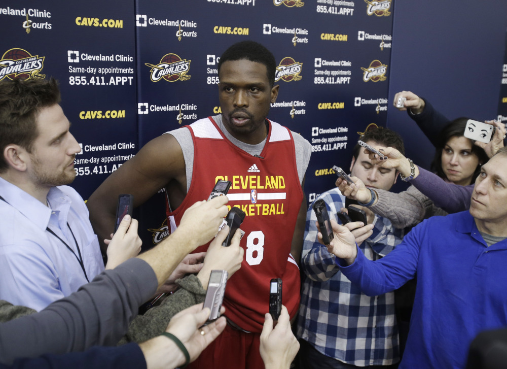 In this Jan. 8, 2014, file photo, then-Cleveland Cavaliers forward Luol Deng talks with reporters after practice in Independence, Ohio.