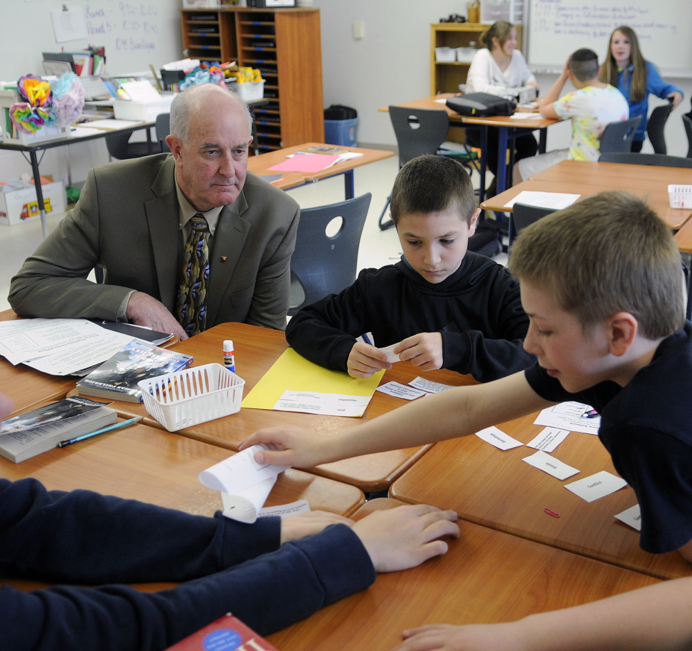 Education Commissioner Jim Rier observes Cony High School seventh-graders earlier this year as they work on a language arts problem at the Augusta school.