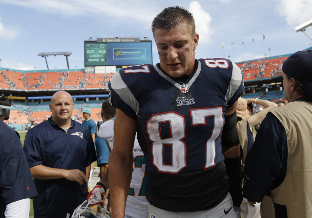 New England Patriots tight end Rob Gronkowski walks off the field Sunday after the Patriots were defeated by the Miami Dolphins 33-20 in Miami Gardens, Fla.