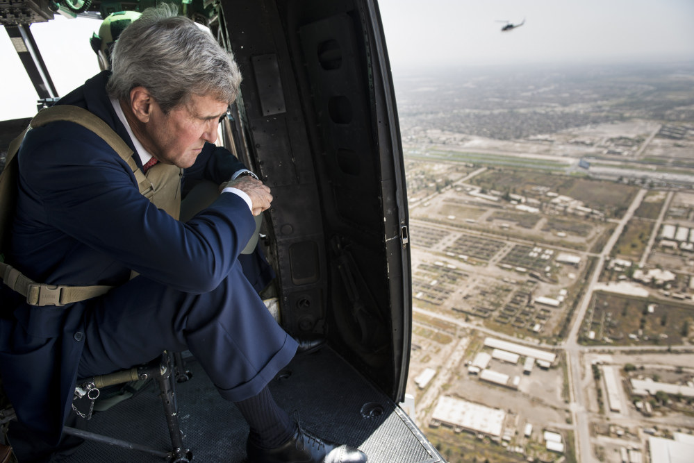 U.S. Secretary of State John Kerry looks out from a helicopter over Baghdad Wednesday. Kerry is in the Mideast to discuss ways to bolster the stability of the new Iraqi government and combat the Islamic State militant group that has taken over large swaths of Iraq and Syria.