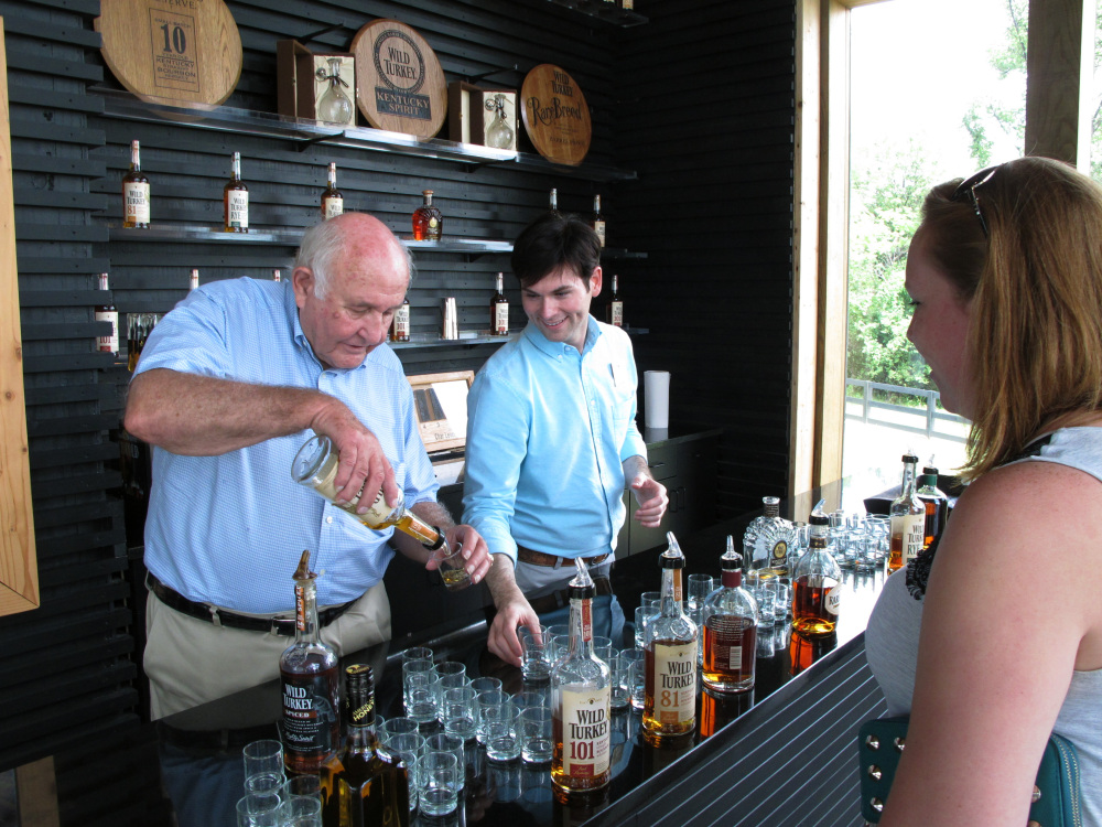 Wild Turkey master distiller Jimmy Russell pours a sample of the whiskey he makes to a visitor at the distillery near Lawrenceburg, Ky.  During his 60 years in the bourbon-making business, Russell has seen his duties expand to brand ambassador to promote Wild Turkey.