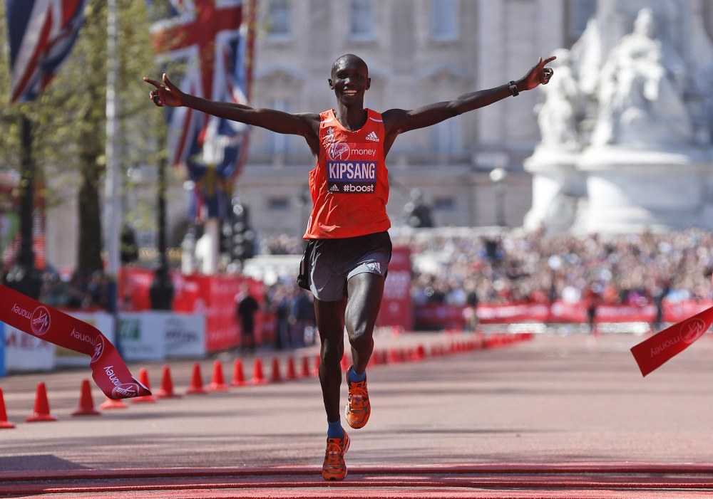 In this April 13, 2014, file photo, Wilson Kipsang of Kenya celebrates his win as he crosses the finish line at the London Marathon.