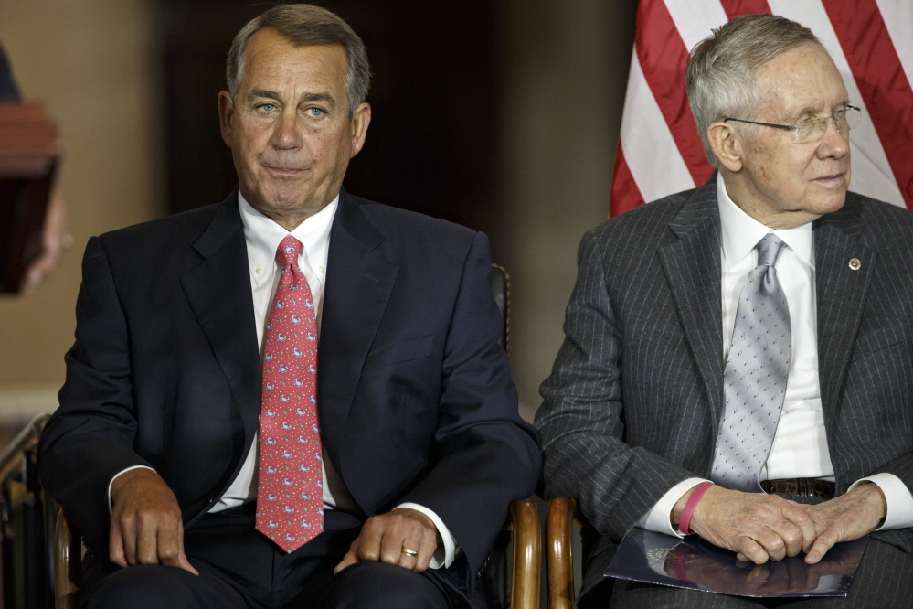 House Speaker John Boehner of Ohio, left, sits with Senate Majority Leader Harry Reid of Nevada, Wednesday on Capitol Hill. Behind the scenes, leaders are trying to put finishing touches on legislation preventing an Oct. 1 federal shutdown and financing the government into December, when Congress will return to work.