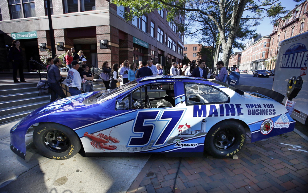 A race car being billed as the “Maine Open for Business Chevrolet,” is introduced tot he public, Friday, Sept. 12, 2014, in Portland, Maine. The marketing slogan was introduced by Maine Gov. Paul LePage. The high-speed billboard for Maine was partially funded by taxpayers. (AP Photo/Robert F. Bukaty)