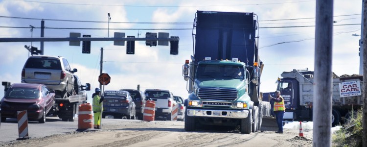 Contractors build the road bed on Western Avenue in Augusta on Monday ahead of paving scheduled for this week.