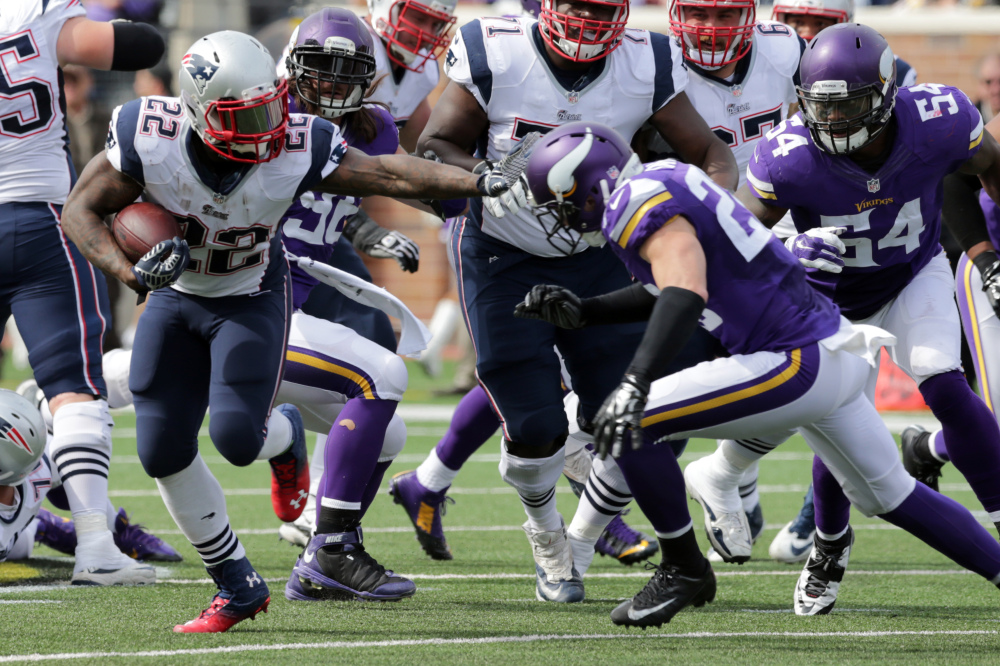 New England Patriots running back Stevan Ridley (22) carries the ball for a 16-yard gain as Minnesota Vikings free safety Harrison Smith defends during the fourth quarter Sunday in Minneapolis. The Patriots won 30-7.