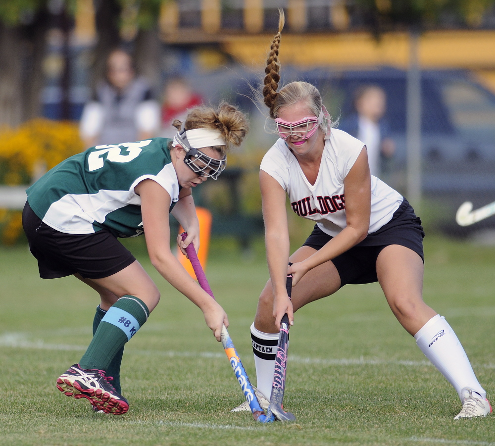 Hall-Dale High School’s Nicole Pelletier, right, and Winthrop High School’s Kat Hajduk try to gain control of the ball Monday in Farmingdale.