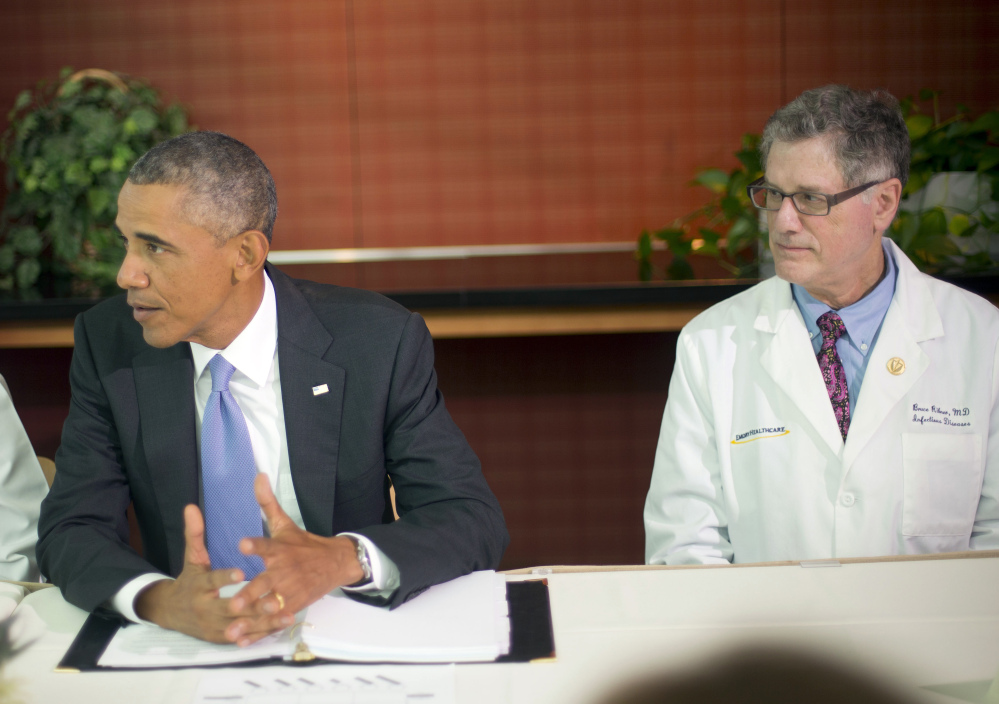 President Barack Obama talks during a meeting with Emory University doctors and healthcare professionals at the Centers for Disease Control and Prevention in Atlanta on Tuesday. Sitting with Obama is Dr. Bruce S. Ribner, professor of medicine in the School of Medicine and Department of Medicine, Division of Infectious Diseases.