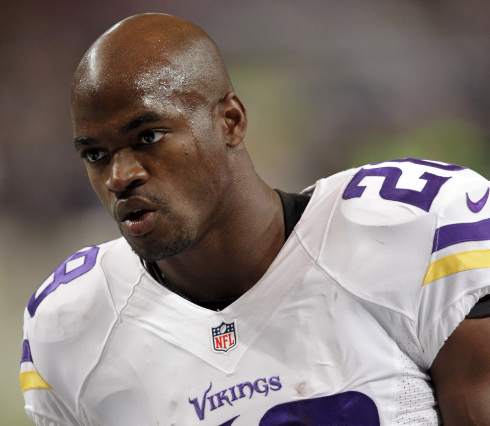 In this file photo, Minnesota Vikings running back Adrian Peterson warms up for an NFL football game against the St. Louis Rams in St. Louis. The Vikings benched Peterson for Sunday’s game after his attorney said he had been indicted by a Texas grand jury on a charge of child abuse.