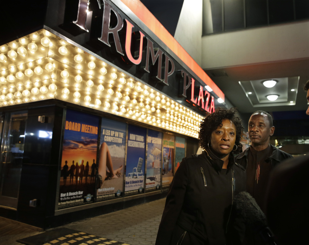 Ruth Hardrick, a dealer who worked at Trump Plaza Hotel & Casino for 26 years, stands with friend, Anthony Powell, on The Boardwalk, as she answers a question after the casino closed early Tuesday in Atlantic City, N.J.